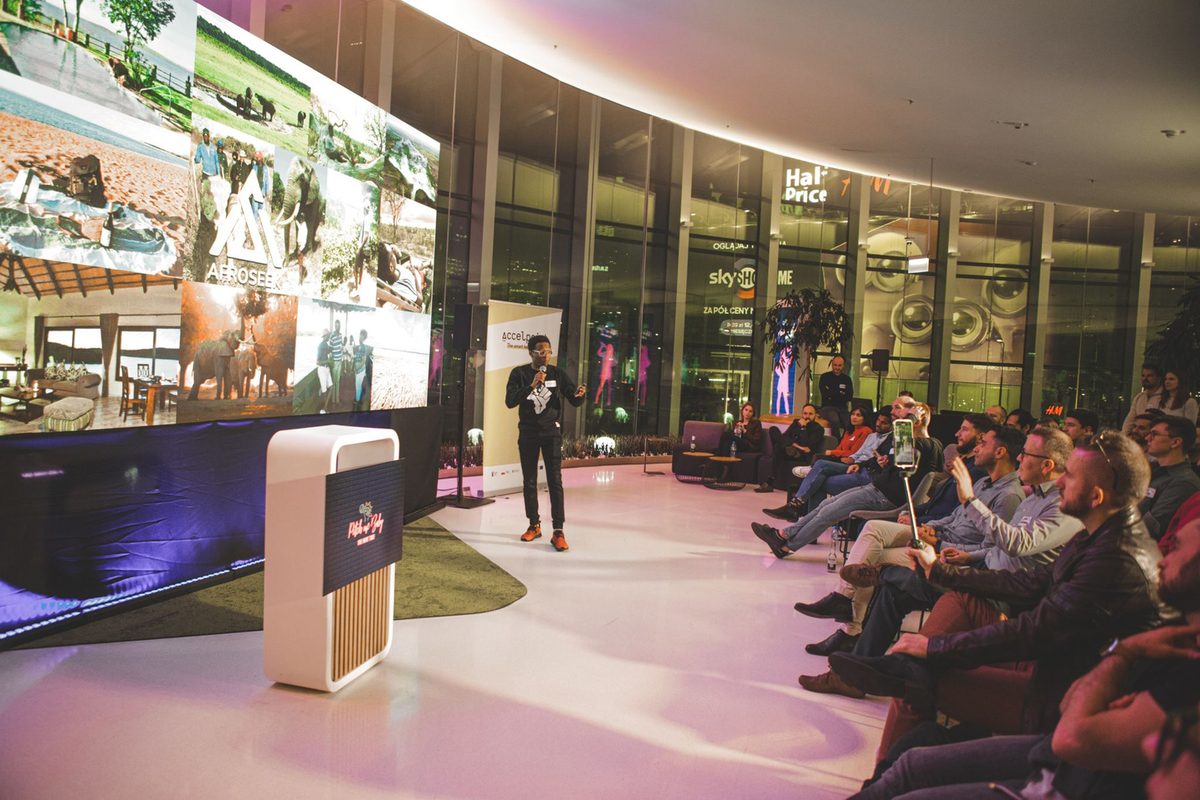Afroseek founder presenting the tourism MVP on stage to a seated audience